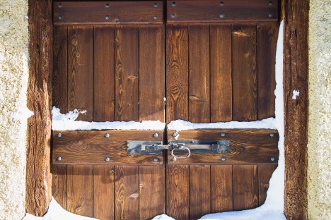 a wooden barn door with snow